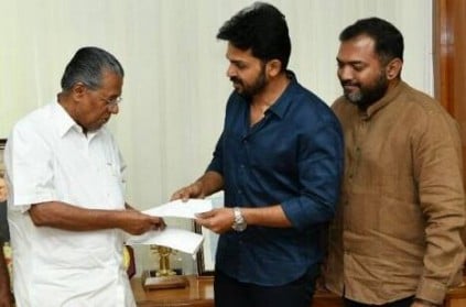 Actor Karthi personally hands Kerala CM check for Rs 25 lakhs
