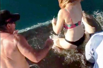 Woman gets pulled in by shark Woman gets pulled in by shark